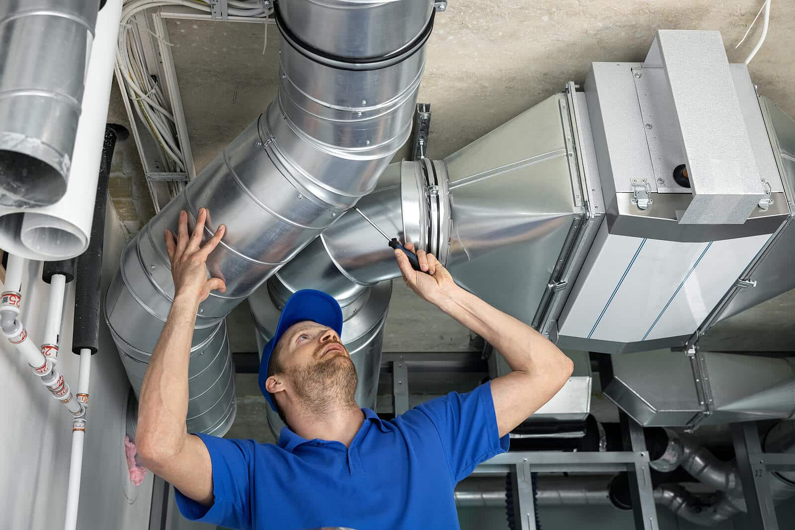 HVAC technician inspecting and repairing air ducts in Rancho Santa Margarita